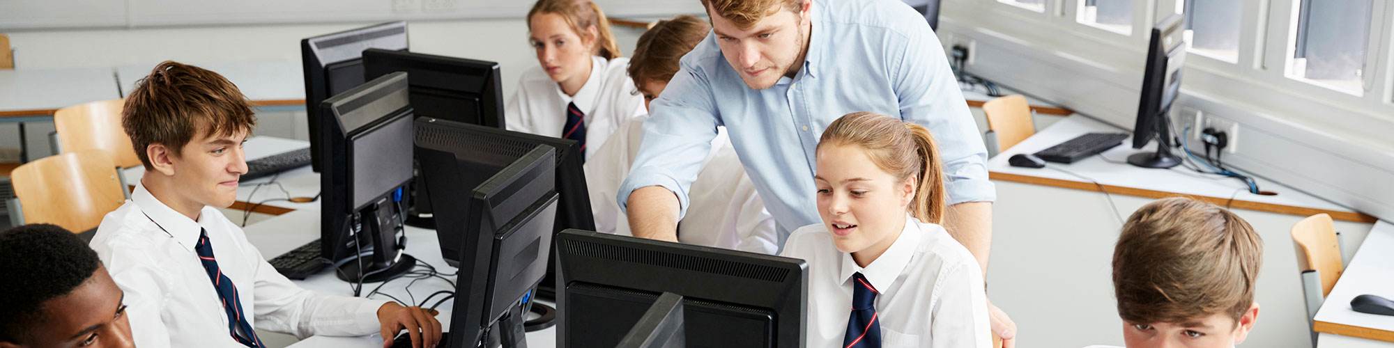 Teacher with pupils in Wrexham classroom